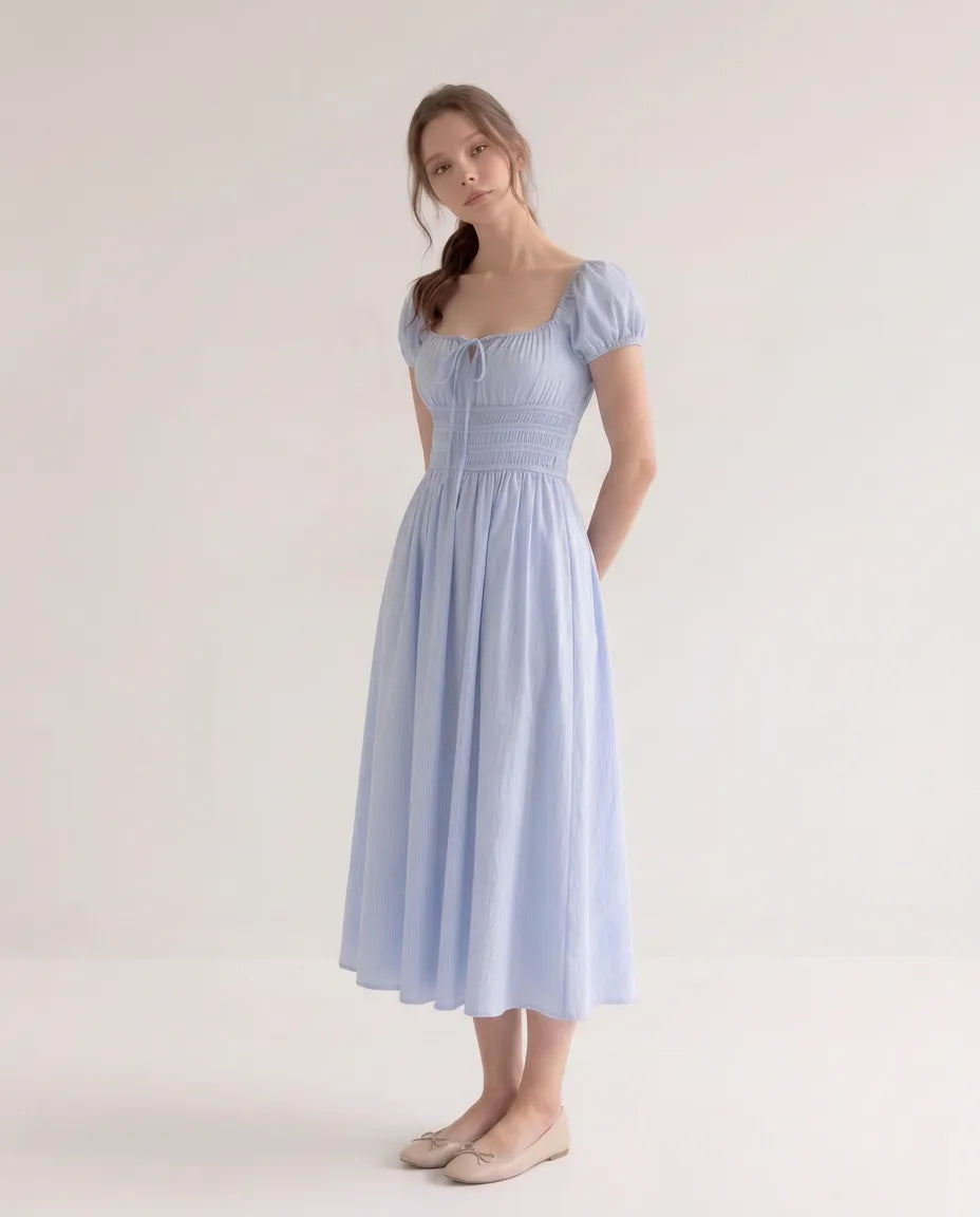 Model wearing the Celeste Midi Dress in blue