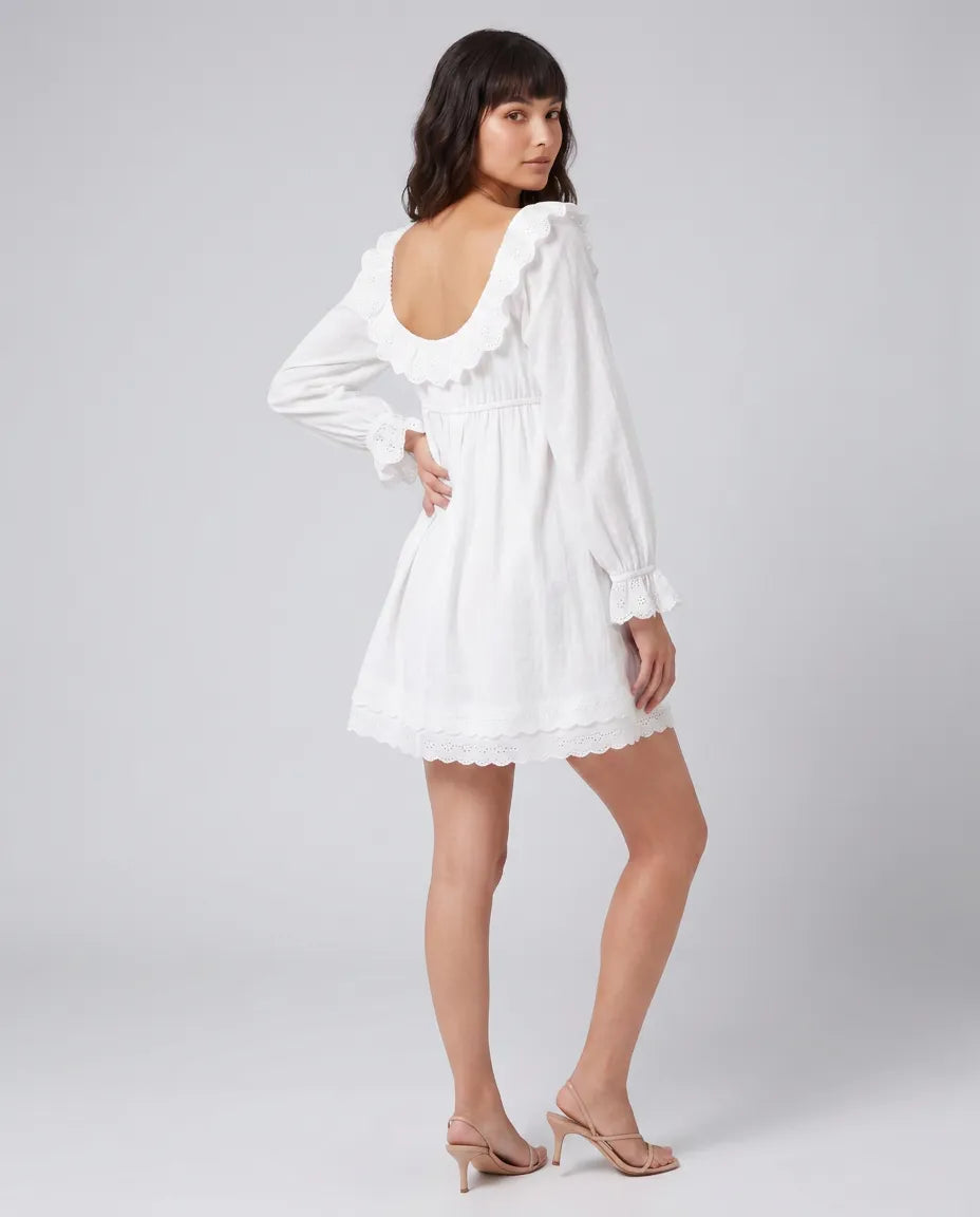 Back view of the Elodie Ruffle Mini Dress in white