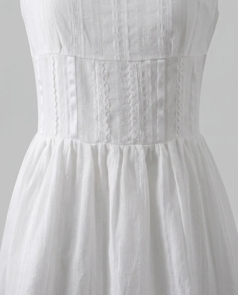 Close product view of the Amelie Mini Dress fitted waist panel and gathered skirt