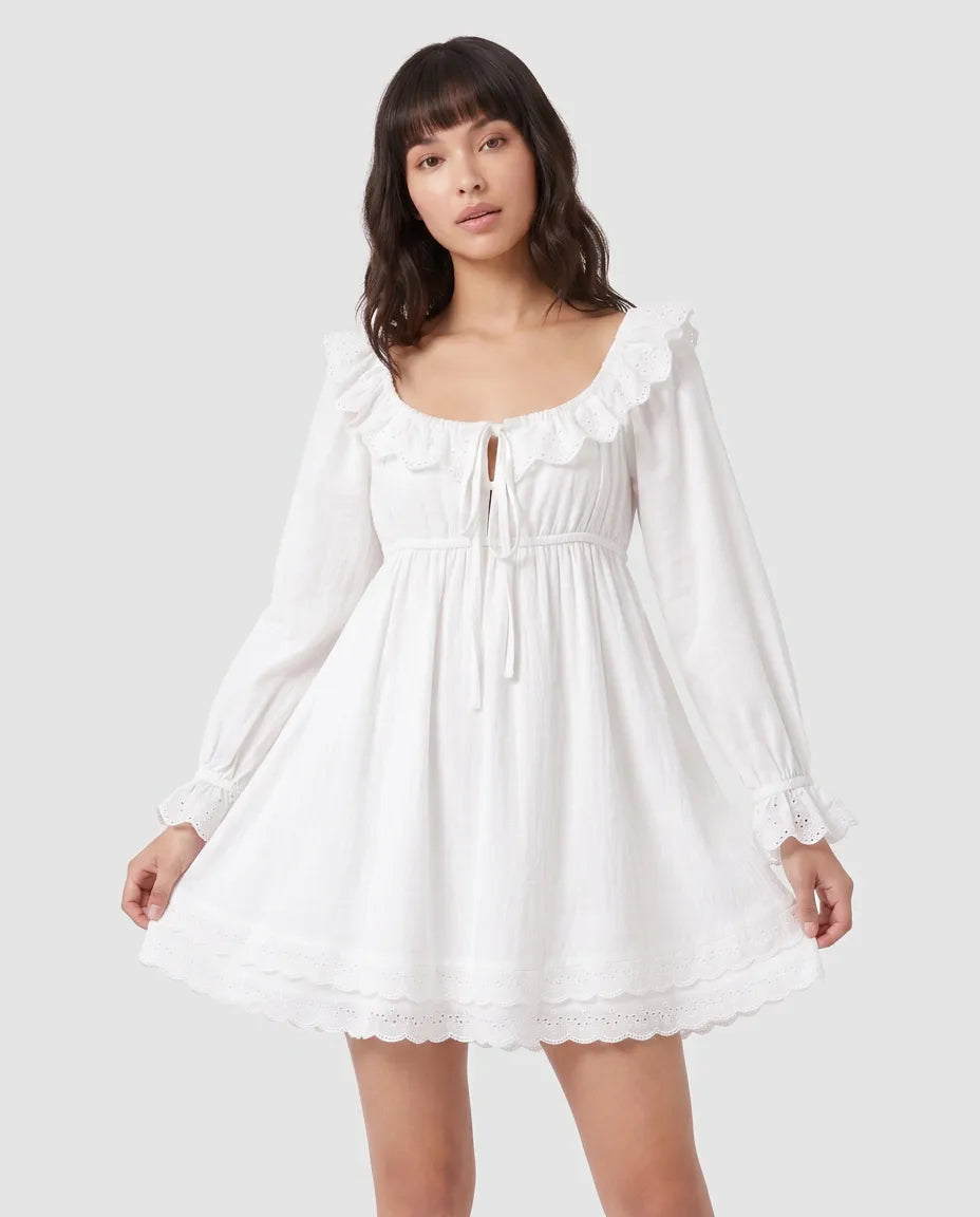 Full-length view of the Elodie Ruffle Mini Dress in white