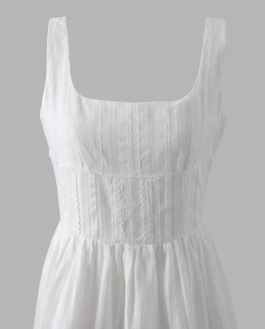 Close product view of the Amelie Mini Dress square neckline, textured bodice, and wide straps
